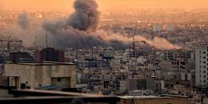 Smoke rises during a US-Israeli attack on Tehran. 