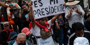 ‘My president’:Supporters of former president Pedro Castillo protest his arrest in Lima on December 9.