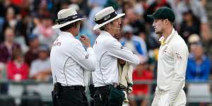 Cameron Bancroft is questioned by umpires Richard Illingworth (left) and Nigel Llong on that famoyus day in Cape Town.