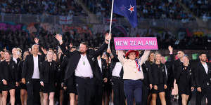 Tom Walsh,flag bearer of Team New Zealand leads the team out during the opening ceremony.