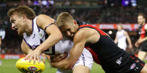 Bombers skipper Dyson Heppell lays a desperate tackle on Fremantle’s Mitch Crowden.