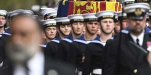 Royal Navy Sailors walk ahead and behind the coffin of Queen Elizabeth II