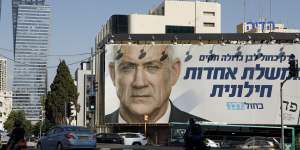 Pedestrians pass a billboard election poster for Benny Gantz,leader of the Blue and White party,in Tel Aviv. 