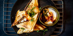 Ma po tofu jaffles with optional dipping sauce.