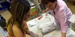 Election officials empty a ballot box to count votes at a polling station in Pamplona,northern Spain,on Sunday.