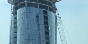 Crane on Packer's tower swings in high winds,smashing window