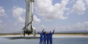 Jeff Bezos,second from left,in front of the rocket that landed safely after their launch from the spaceport near Van Horn,Texas,in July 20. 