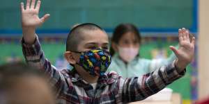 Children in a Los Angeles elementary school wear masks in April. Similar scenes await Victorian classrooms later this month.