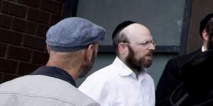 People inspecting the damage at the Adass Israel synagogue in Ripponlea. 