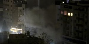 An explosion caused by Israeli airstrikes is seen from a Hamas-affiliated insurance company in Gaza City.