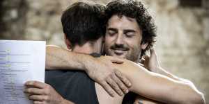 Danny Ball hugs Tom Conroy during rehearsals for Holding the Man at Belvoir.