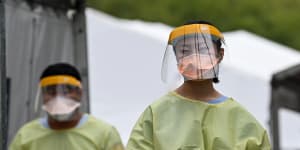 Healthcare workers dressed in PPE are seen at the Royal Prince Alfred Hospital’s COVID-19 clinic in Sydney on Sunday.