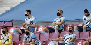 Sydney FC's substitutes sit in the stands,socially distanced,at Doha's Khalifa International Stadium.