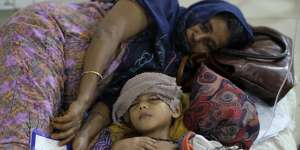 A child suffering from dengue receives treatment in hospital in Dhaka.