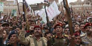 Houthi rebels hold up their weapons to protest against Saudi-led air strikes during a rally in Sana'a last week.