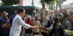 Indonesian President Joko Widodo greets people at Pal Merah traditional market,in Jakarta,Indonesia on June 26,2023.