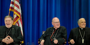 Cardinal Timothy Dolan,centre,with fellow US cardinals Joseph Tobin,left,and Daniel Di Nardo,right,address the media after electing the Pope.