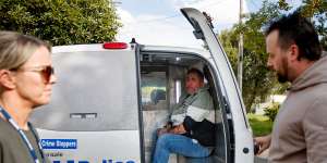 Philip Langsdorf is placed inside a police van.