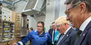 Defence Minister Richard Marles (right) and then-British PM Boris Johnson talk to Autumn Benson,a first-year-apprentice at BAE Systems,at the company’s submarine shipyards in the British port of Barrow-in-Furness in August last year.