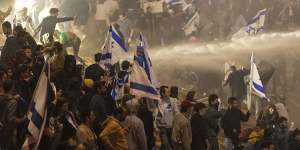 Israeli police use a water cannon to disperse demonstrators blocking a highway on Monday.