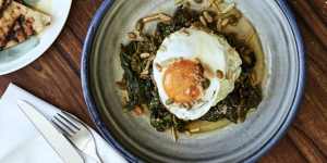 Wild greens braised in tomato,olive oil,grain,nuts,and fried eggs.