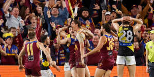 Joe Daniher celebrates with Lions teammates as he puts his side up with a minute to go.