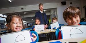 Port Melbourne Primary School prep students Brooklyn,Chloe,Felix and Gonzalo use an explicit instruction approach to learning to read with principal Tom Cain.