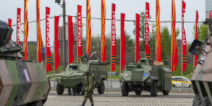 A Russian soldier guards an exhibition of tanks,vehicles and guns captured from Ukrainian armed forces and on display near the World War II museum in Moscow.