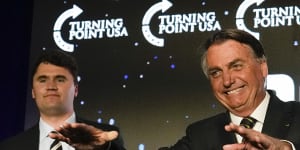 Brazil’s right wing former President Jair Bolsonaro,right,speaks alongside Turning Point USA founder Charlie Kirk,at a TPUSA event at Trump National Doral,Miami.