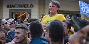 Presidential candidate Jair Bolsonaro grimaces right after being stabbed in the stomach during a campaign rally in Juiz de Fora.