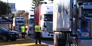Trucks stop at the Queensland border in Coolangatta.