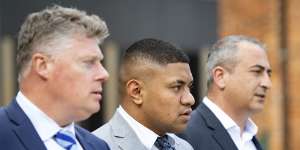 Manase Fainu (centre) is on trial in Parramatta District Court.