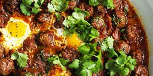 Meatballs and eggs in spicy tomato sauce.