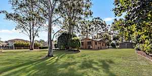 The home features expansive living areas,water tanks and a four-bay shed.