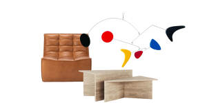 “Slouch” sofa chair;Abstract art hanging;“The Duo” travertine coffee table.