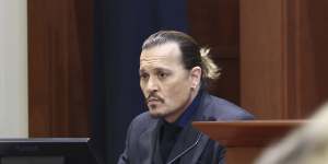 Amber Heard speaks with her legal team as actor Johnny Depp returns to the stand.