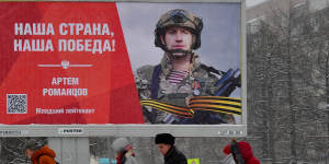 People walk past a billboard honouring a Russian serviceman and reading “Our country,our victory!” in Saint Petersburg last month.