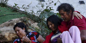 Flory Teletor,a victim of gun violence,needs to be carried up the steps to the street above her sister and brother-in-law’s house in Guatemala City.