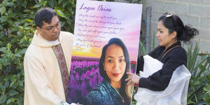 A picture of Logee Osias is placed at outside a church at a vigil for the mother of four held in Bendigo on Tuesday.