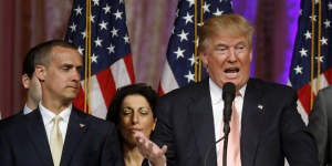 Donald Trump's former campaign manager Corey Lewandowski listens at left as Trump speaks in Florida.