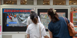 Tokyo’s residents stop to watch news of Shinzo Abe’s attempted assassination. 