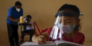 A child wears a mask and face shield at a school in Montebello in Mexico.