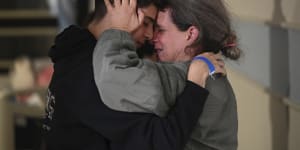 Sharon Hertzman,part of the second batch of hostages to be released,embraces a relative as they reunite at Sheba Medical Centre in Ramat Gan,Israel. Her daughter Noam,12,not pictured,was also released.