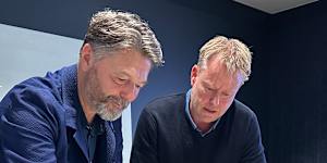 Prior + Partners director of master planning Jonathan Rose and Arcadis Brisbane Games and legacy lead Paul Allan at the firm’s Brisbane office,looking over a map of the Victoria Park site.