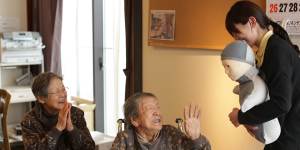 Residents of an aged-care facility meet a remote-controlled “humanoid” robot in Natori,Japan.