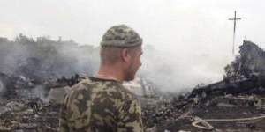 An armed pro-Russian separatist stands at the site of the Malaysia Airlines Boeing 777 plane crash.