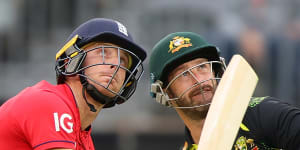 England’s Jos Buttler and Australian wicketkeeper Matthew Wade watch the ball go for six at Optus Stadium.