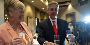 Georgia Secretary of State Brad Raffensperger,grabs a glass of champagne to toast with his wife Tricia after declaring victory.