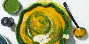 Roast pumpkin soup swirled with spinach puree and cream.