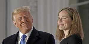 US President Donald Trump,left,rushed the appointment and swearing in of Amy Coney Barrett,associate justice of the US Supreme Court,last month.